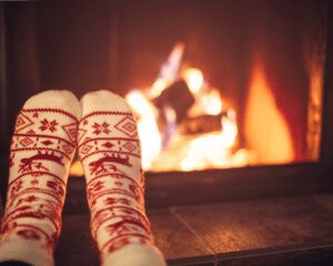 toes in socks warming in front of a fire